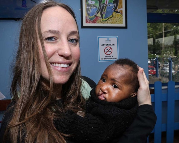 Jessica holds a baby